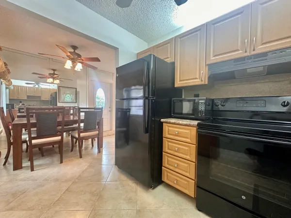 a kitchen with a refrigerator and a sink