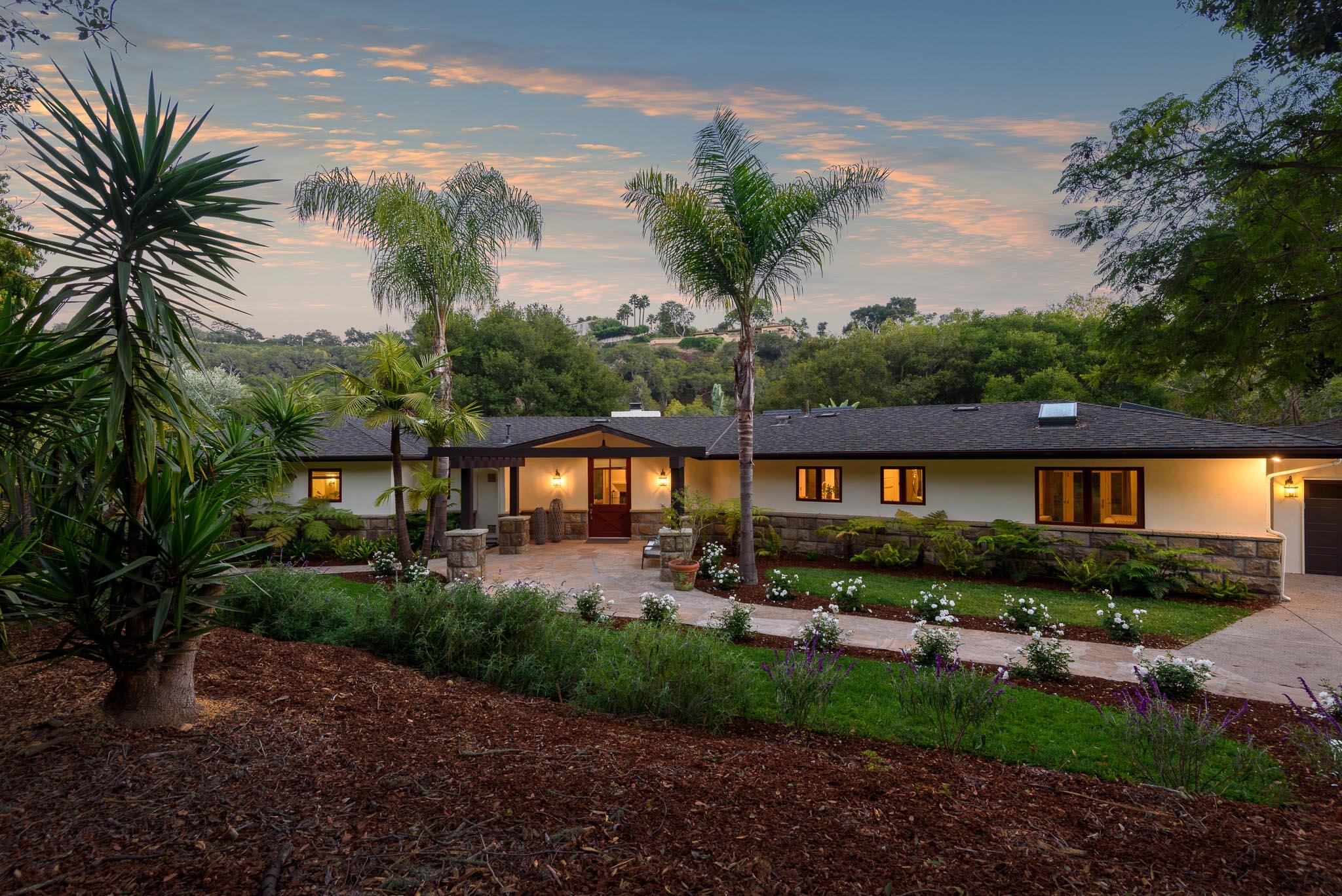 a front view of a house with a garden and patio