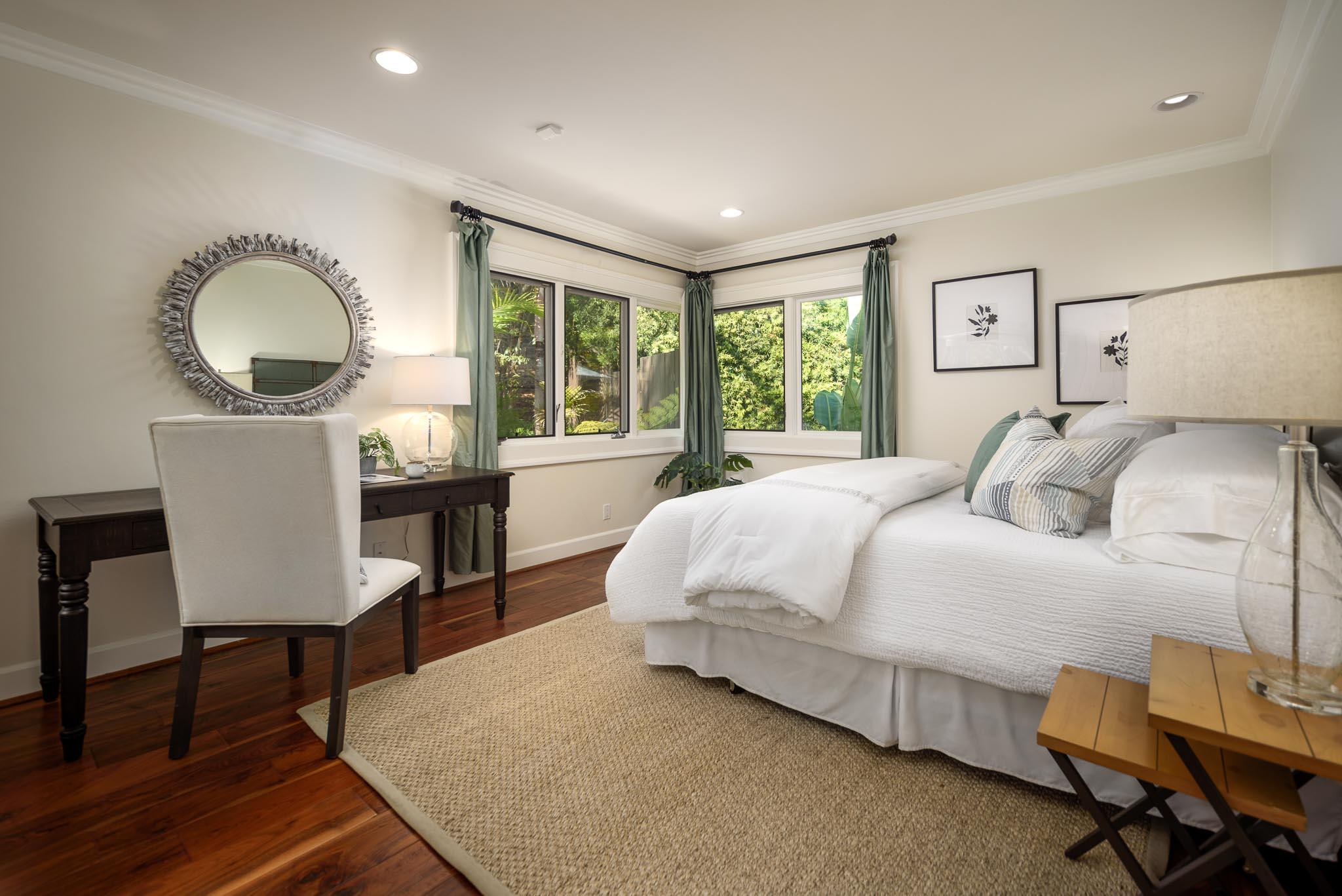 4375 Via Glorieta Santa Barbara, CA 93110 - Photo 16 of 36 a spacious bedroom with a bed a table and large windows