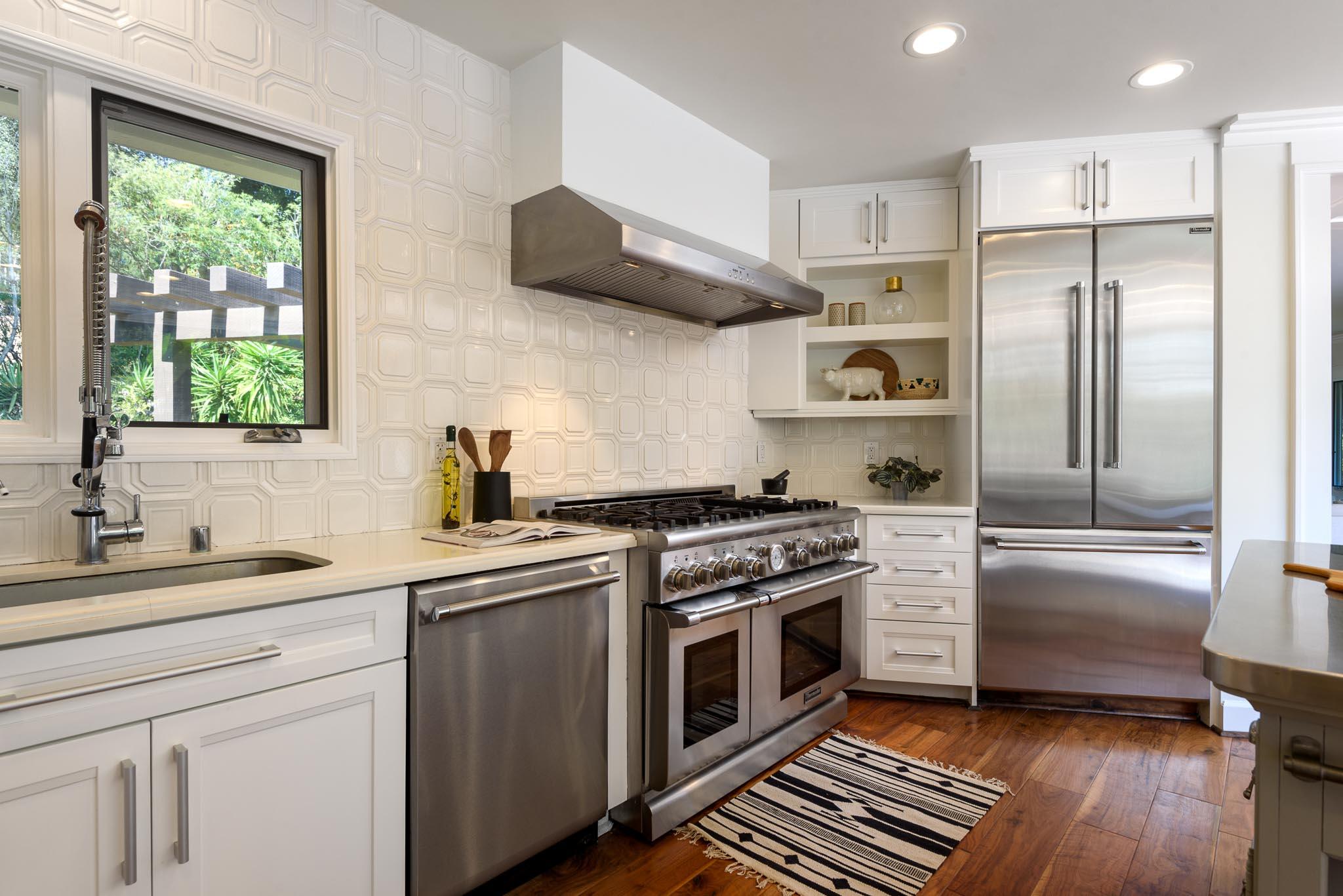 4375 Via Glorieta Santa Barbara, CA 93110 - Photo 8 of 36 a kitchen with stainless steel appliances a stove a sink and a refrigerator