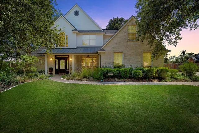 a front view of house with yard and green space