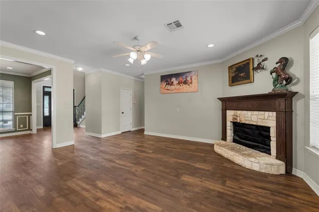 a view of a livingroom with a fireplace a fireplace and wooden floor