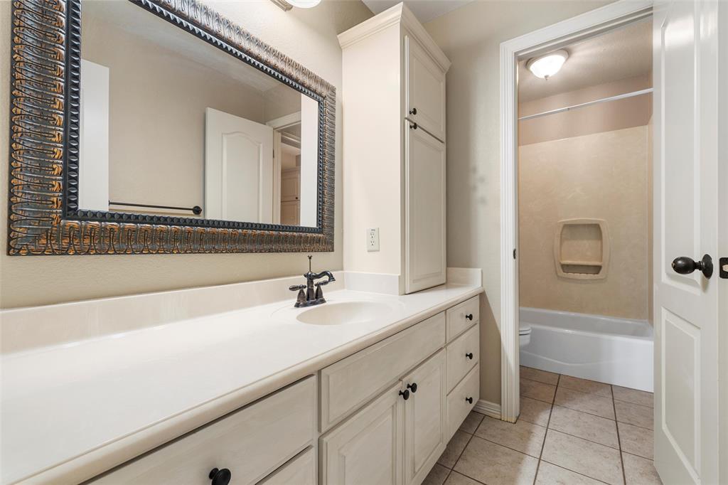 5624 Rosalie Drive Waco, TX 76708 - Photo 18 of 39 a bathroom with a sink and a mirror