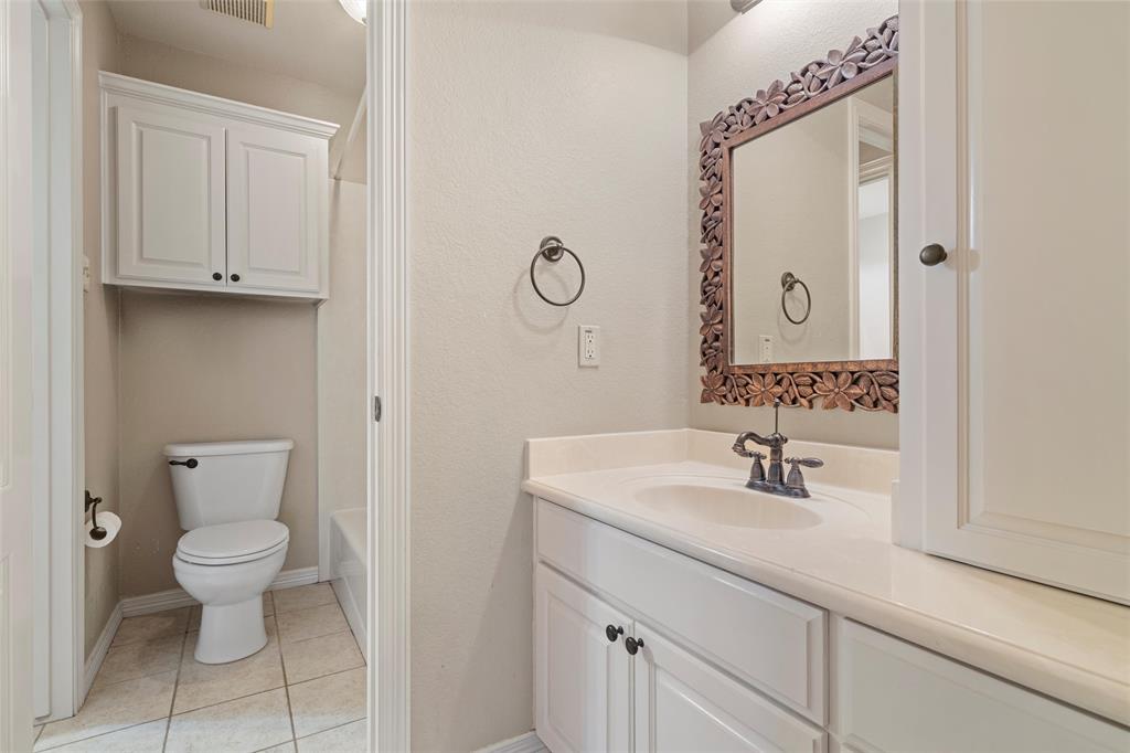 5624 Rosalie Drive Waco, TX 76708 - Photo 19 of 39 a bathroom with a toilet sink and mirror