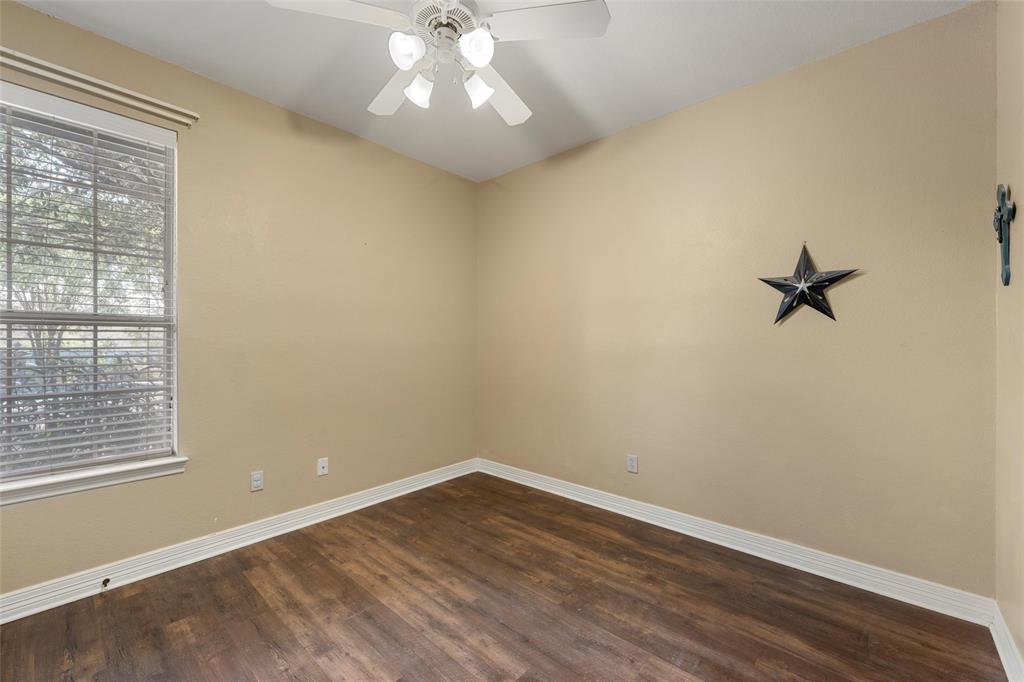 5624 Rosalie Drive Waco, TX 76708 - Photo 23 of 39 wooden floor in an empty room with a window