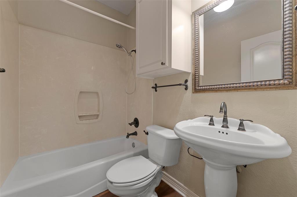 5624 Rosalie Drive Waco, TX 76708 - Photo 25 of 39 a bathroom with a sink a toilet and shower