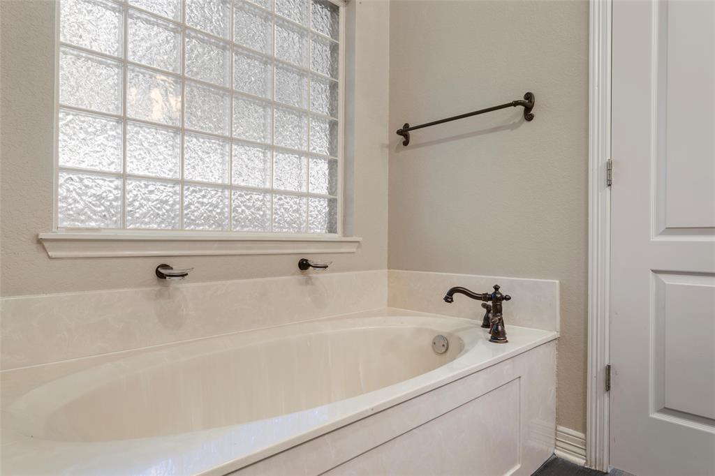 5624 Rosalie Drive Waco, TX 76708 - Photo 31 of 39 a bathroom with a bathtub and a shower