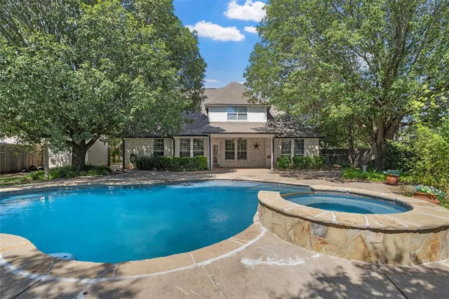 a view of a house with swimming pool and sitting area