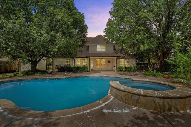 a view of a house with swimming pool and a yard