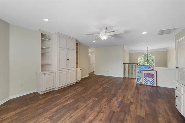 a view of a room with wooden floor and window
