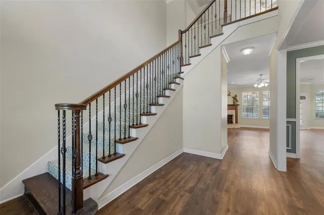 a view of staircase with wooden floor and a chandelier