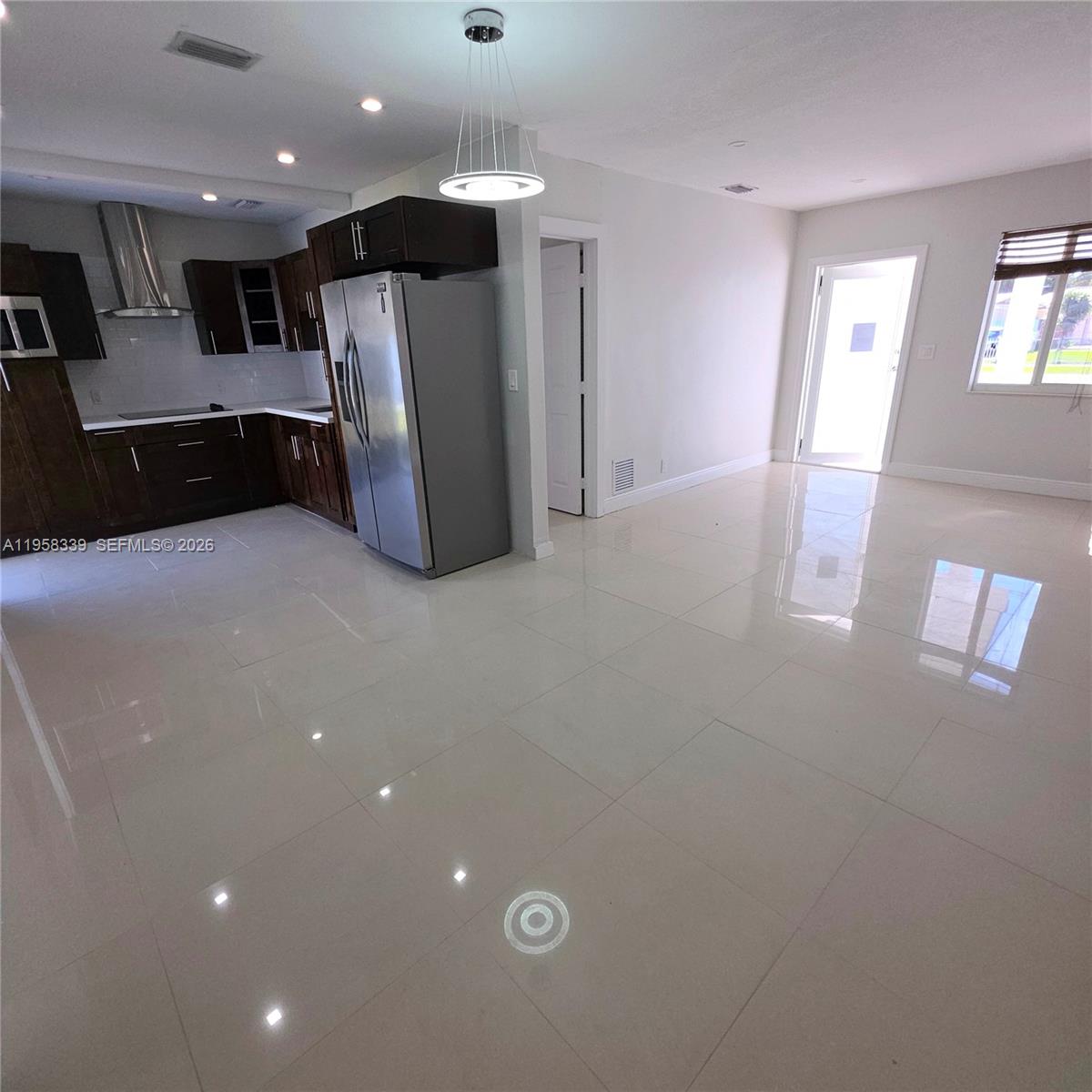 7555 Southwest 28th Street Road Miami, FL 33155 - Photo 4 of 11 a view of a refrigerator in kitchen and windows