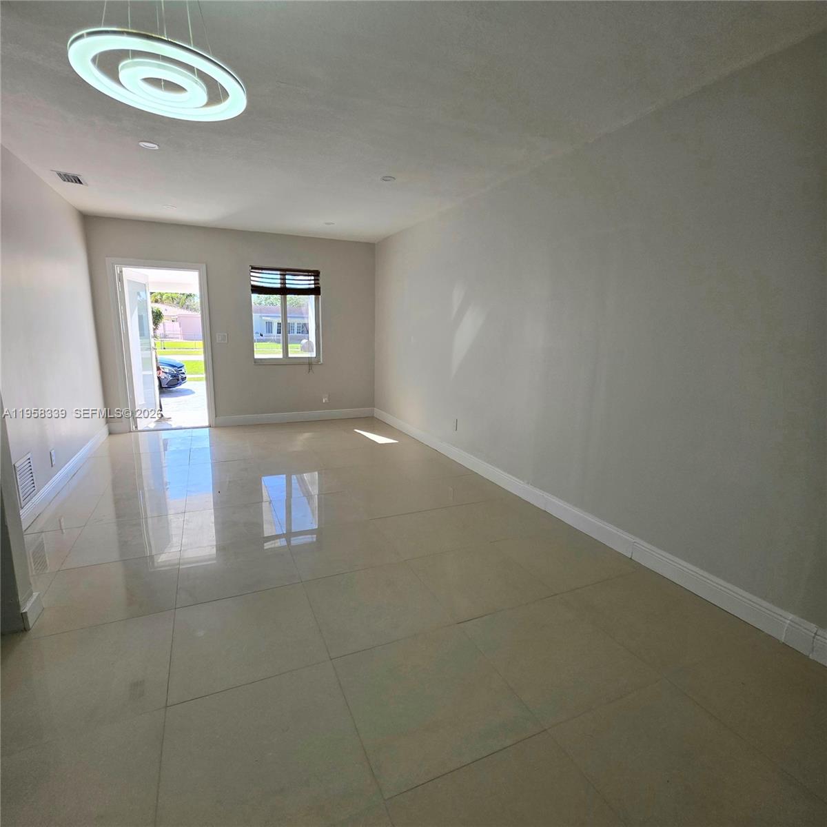 7555 Southwest 28th Street Road Miami, FL 33155 - Photo 8 of 11 an empty room with a empty space and a window