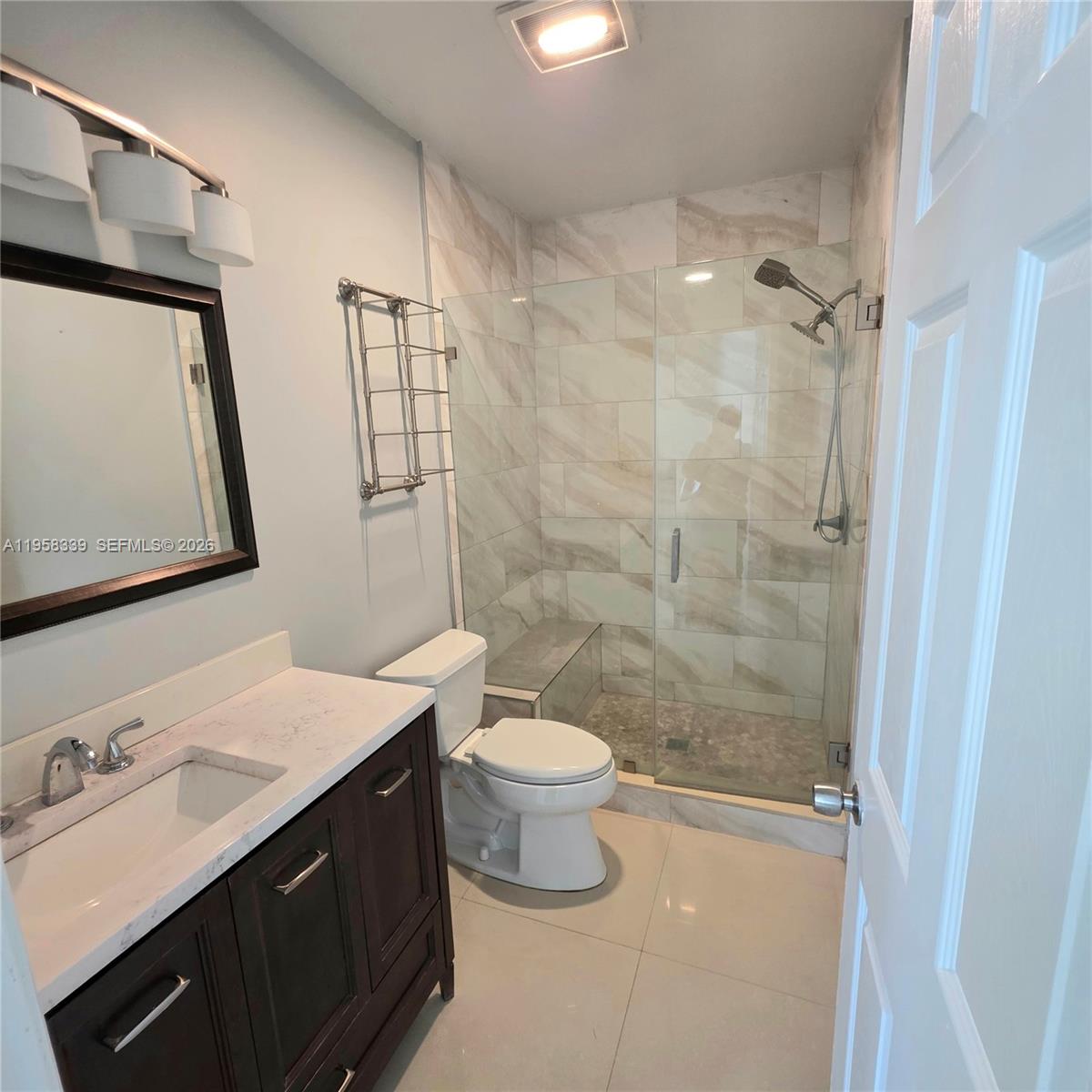7555 Southwest 28th Street Road Miami, FL 33155 - Photo 9 of 11 a bathroom with a double vanity sink toilet and shower