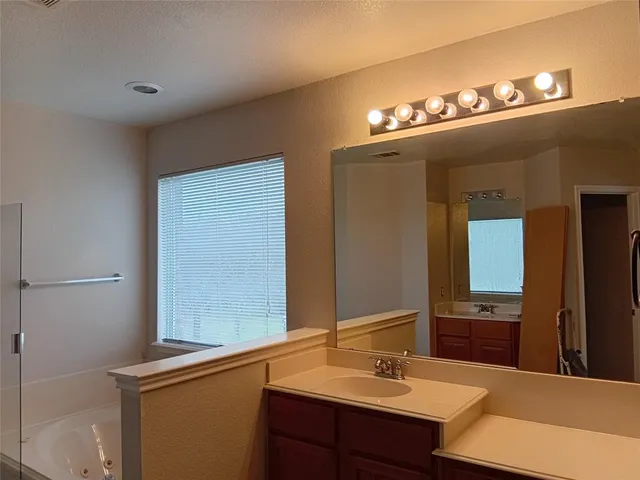a bathroom with a sink vanity and a mirror