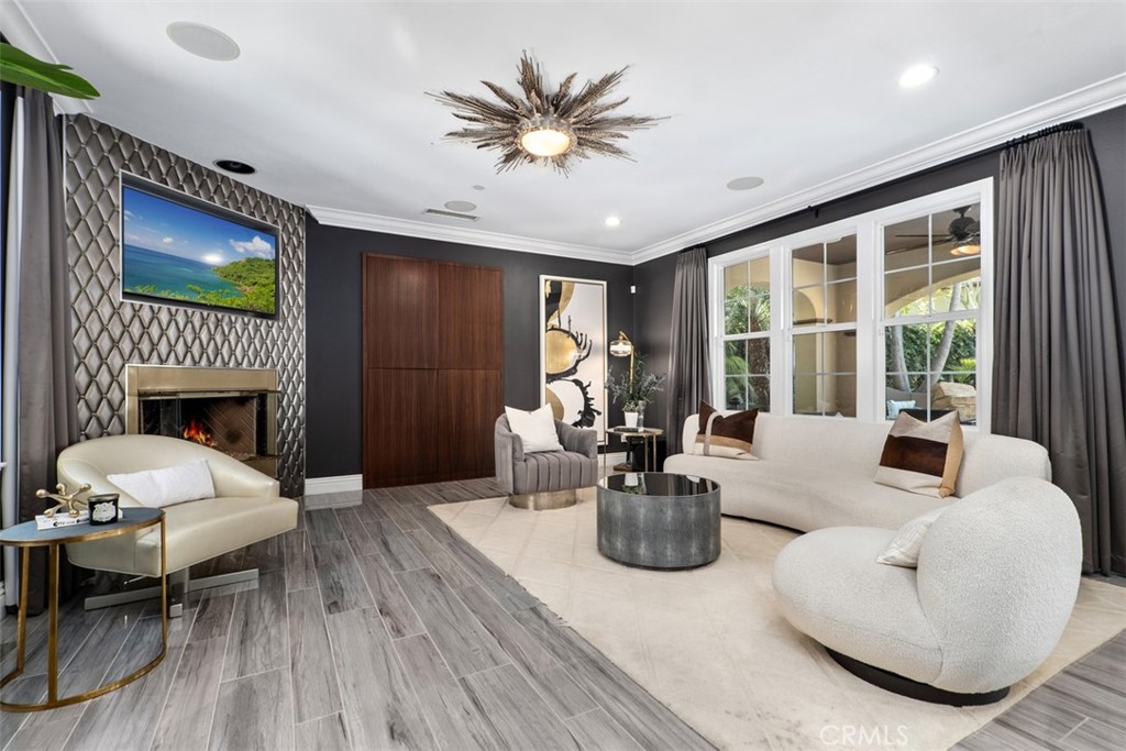 33 Basilica Place Ladera Ranch, CA 92694 - Photo 15 of 59 a living room with furniture a fireplace and a flat screen tv