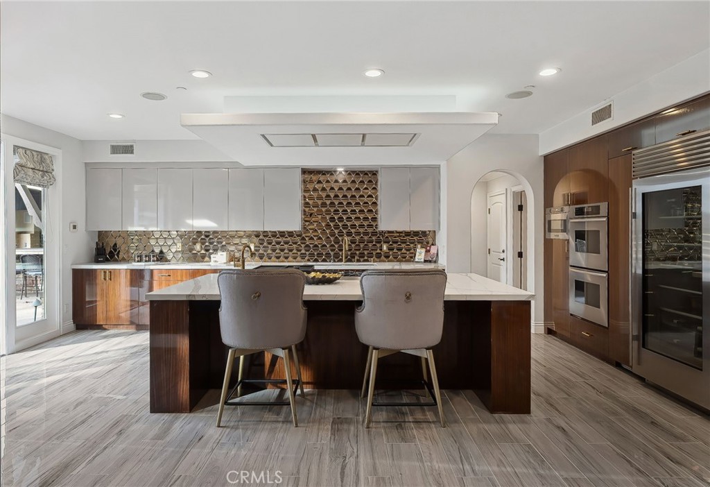 33 Basilica Place Ladera Ranch, CA 92694 - Photo 23 of 59 a kitchen with a table chairs a sink and cabinets