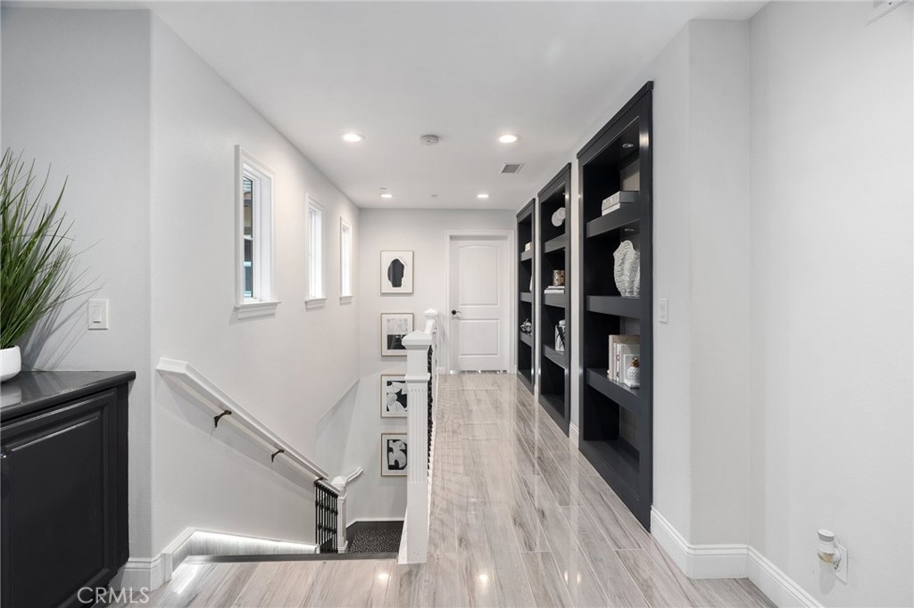 33 Basilica Place Ladera Ranch, CA 92694 - Photo 27 of 59 a view of a hallway with wooden floor and staircase