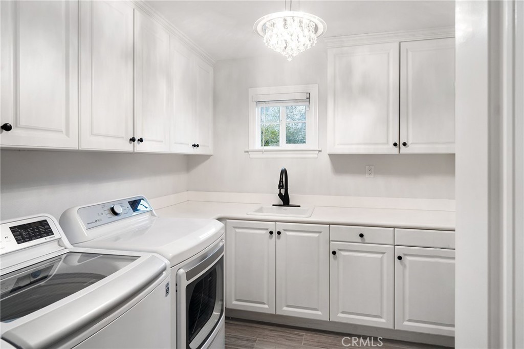 33 Basilica Place Ladera Ranch, CA 92694 - Photo 41 of 59 a kitchen with white cabinets and white appliances