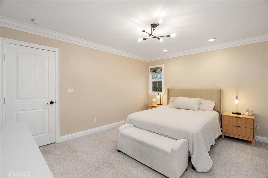 33 Basilica Place Ladera Ranch, CA 92694 - Photo 43 of 59 a bedroom with a bed and a chandelier