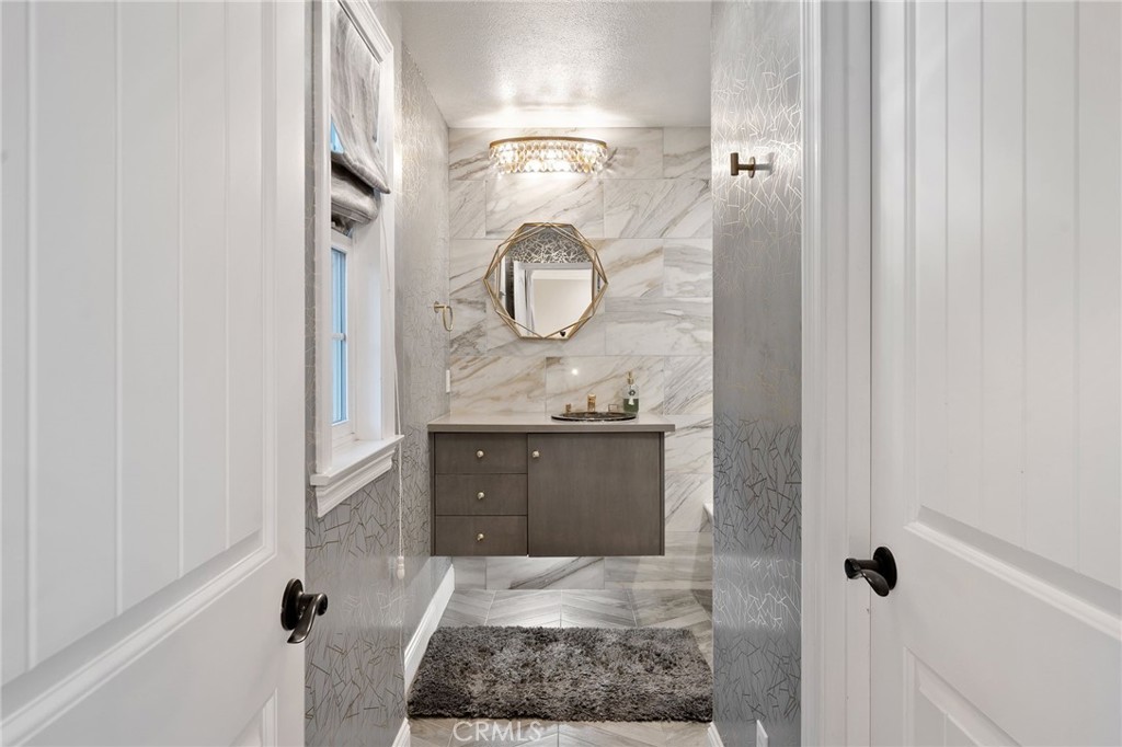 33 Basilica Place Ladera Ranch, CA 92694 - Photo 44 of 59 a bathroom with a granite countertop sink and a mirror