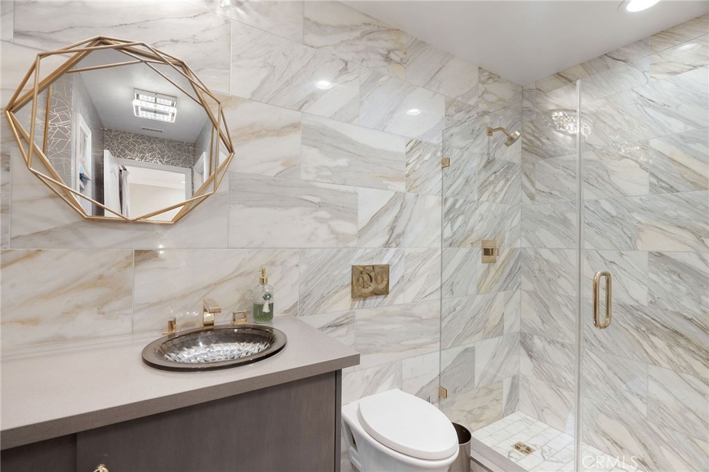 33 Basilica Place Ladera Ranch, CA 92694 - Photo 45 of 59 a bathroom with a sink a mirror and a toilet