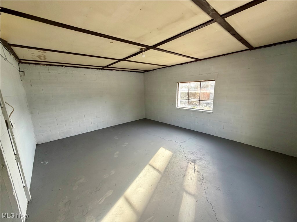 34 West Lewis Street Struthers, OH 44471 - Photo 11 of 14 Unfurnished room featuring concrete block wall and concrete flooring