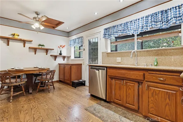 a kitchen with stainless steel appliances granite countertop a sink and cabinets