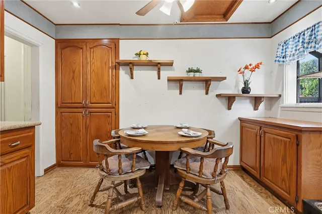 a kitchen with stainless steel appliances a table and chairs in it