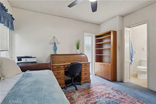 a bedroom with furniture and a rug