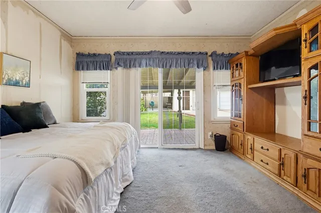 a bed sitting in a bedroom next to a window