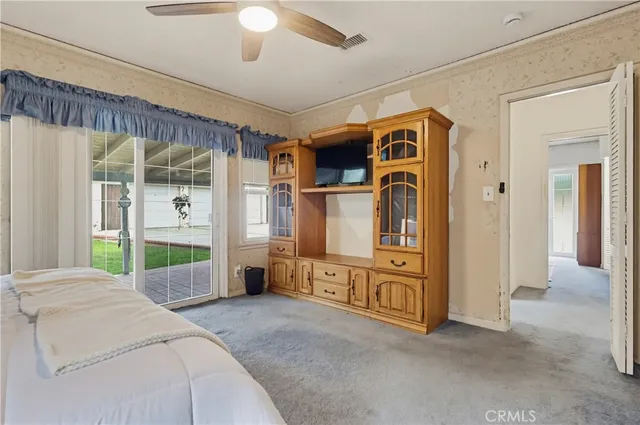 a bed room with a bed and a large window