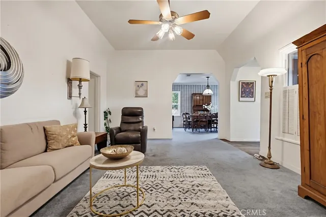 a living room with furniture a rug and a chandelier