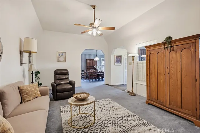 a living room with furniture a rug and a chandelier