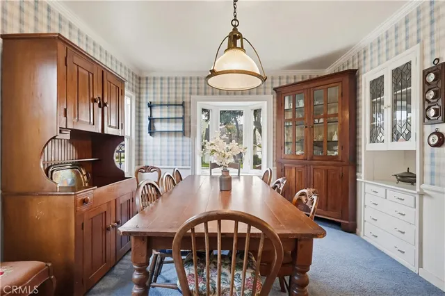 a view of a a dining room with furniture window and wooden floor
