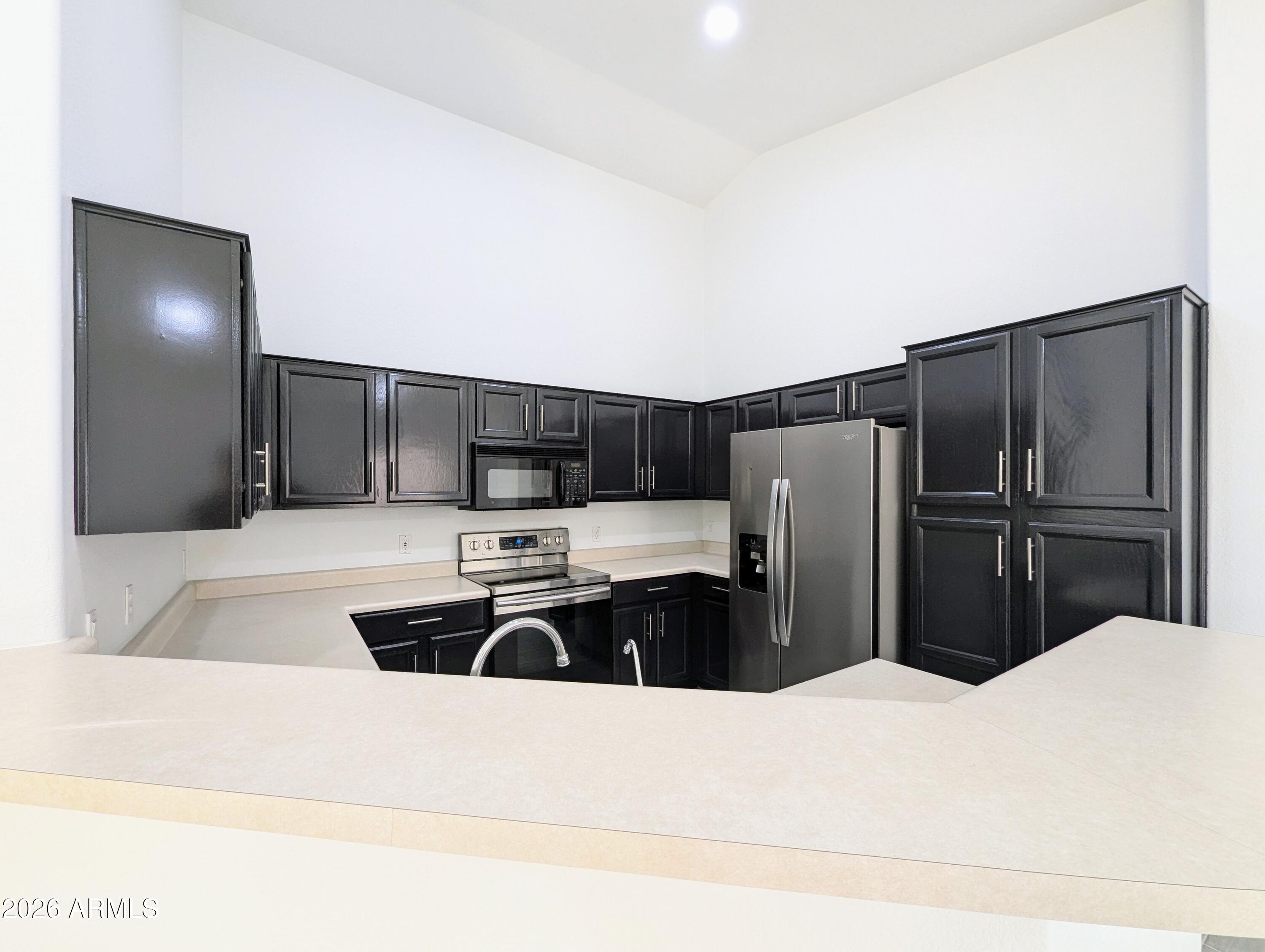 5424 West Wagoner Road Glendale, AZ 85308 - Photo 13 of 37 a kitchen with stainless steel appliances a refrigerator and a stove