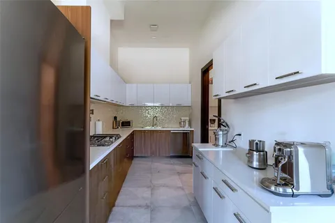 a kitchen with stainless steel appliances a sink and stove