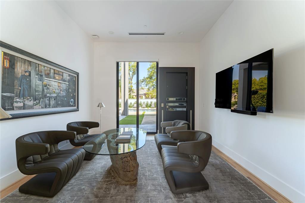 5959 Colhurst Street Dallas, TX 75230 - Photo 21 of 35 a living room with furniture and a flat screen tv