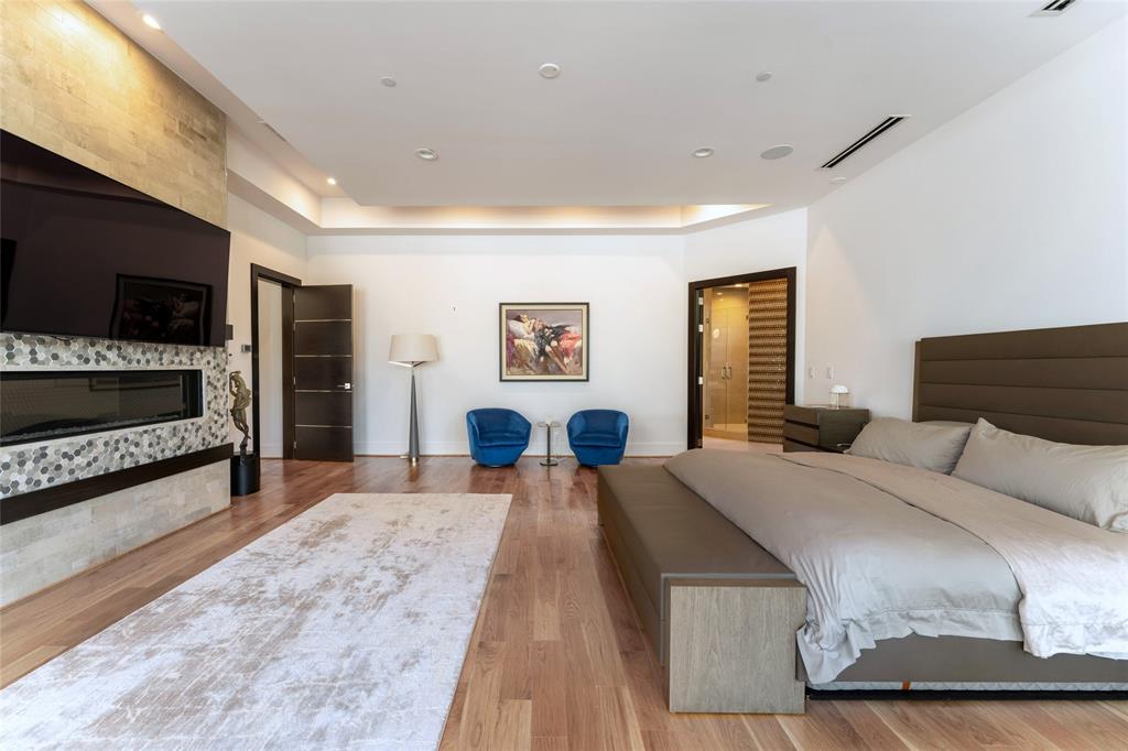 5959 Colhurst Street Dallas, TX 75230 - Photo 23 of 35 a bedroom with a large bed and a flat screen tv