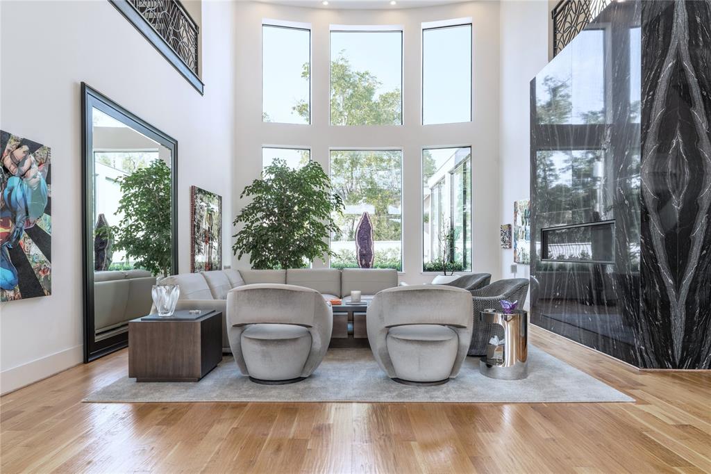 5959 Colhurst Street Dallas, TX 75230 - Photo 8 of 35 a living room with couches potted plants and a large window with garden view