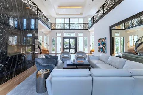 a living room with furniture a chandelier and a fireplace