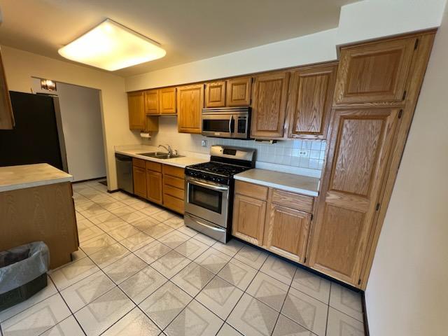 239 North Mill Road, Unit 405A Addison, IL 60101 - Photo 2 of 14 a kitchen with granite countertop a refrigerator and a stove top oven