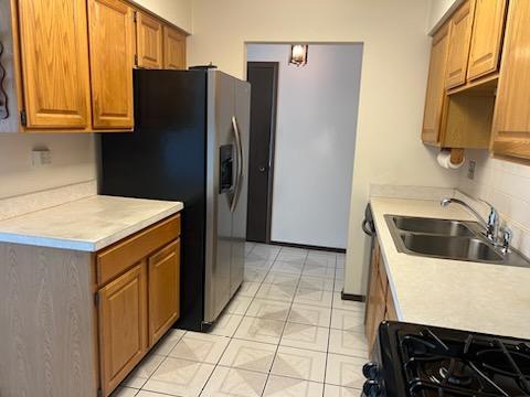 239 North Mill Road, Unit 405A Addison, IL 60101 - Photo 3 of 14 a kitchen with stainless steel appliances a refrigerator and a sink
