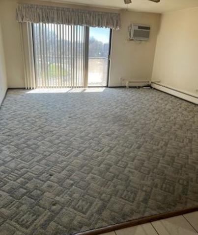239 North Mill Road, Unit 405A Addison, IL 60101 - Photo 6 of 14 a view of an empty room with a window