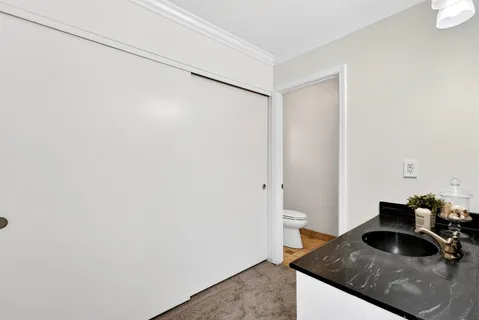 a kitchen with a sink and a toilet