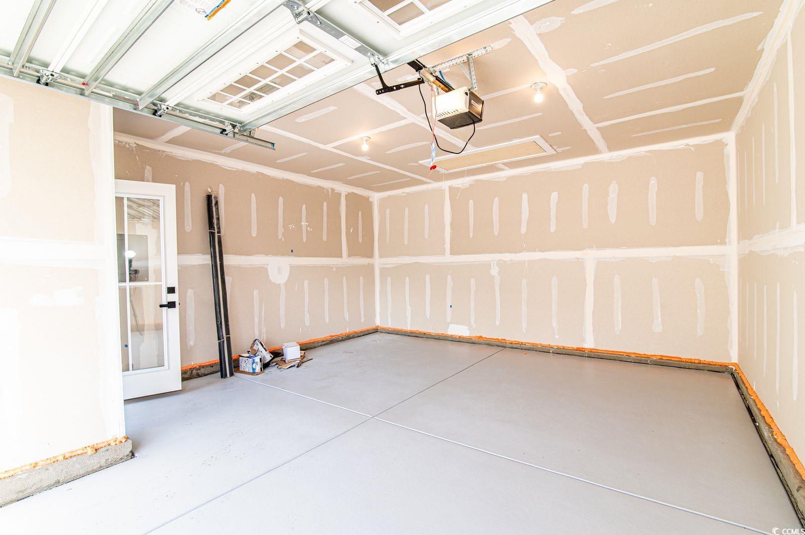 2812 Rowyn Street Longs, SC 29568 - Photo 22 of 27 Garage featuring a garage door opener