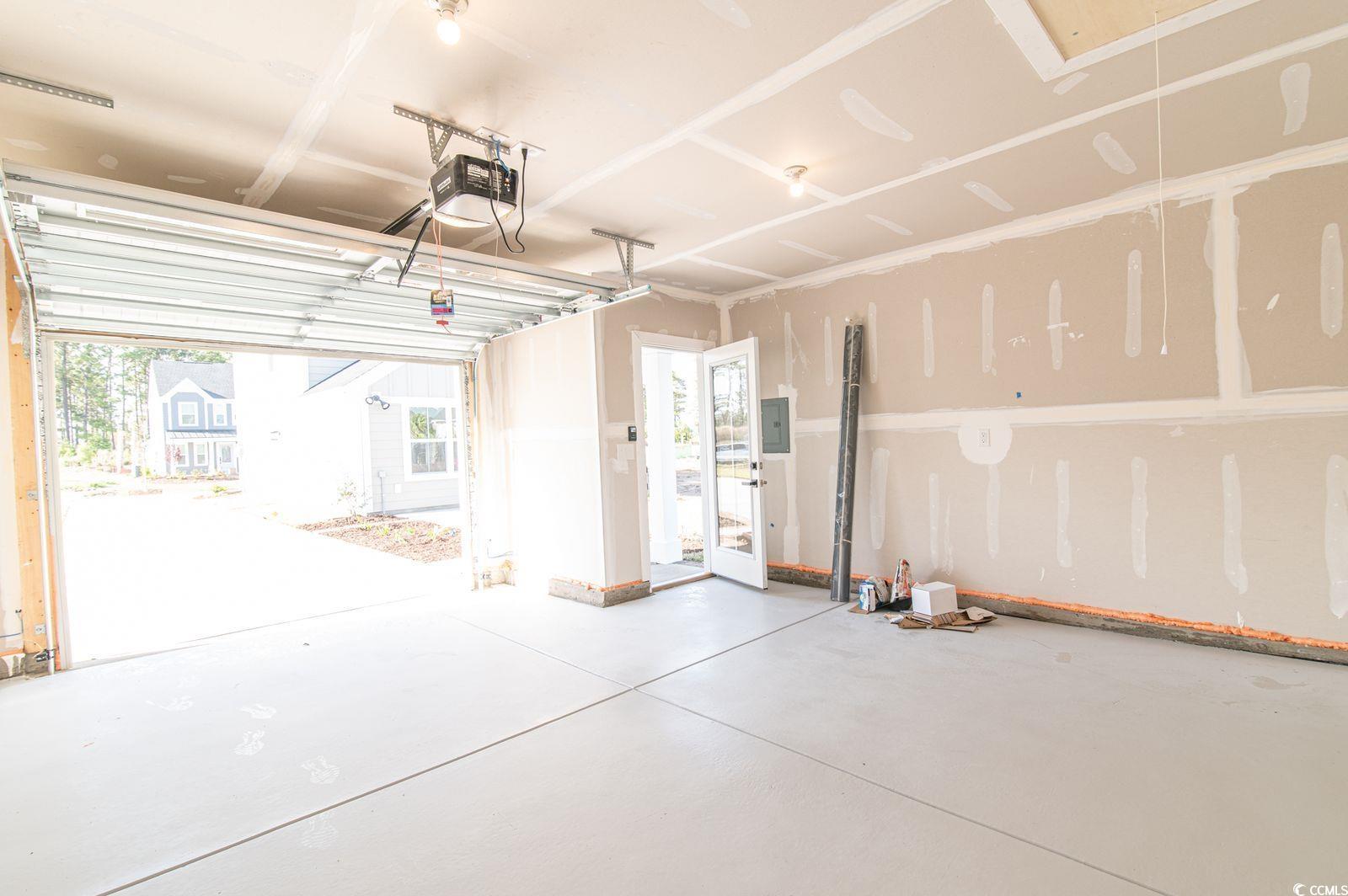 2812 Rowyn Street Longs, SC 29568 - Photo 23 of 27 Garage featuring a garage door opener and electric panel