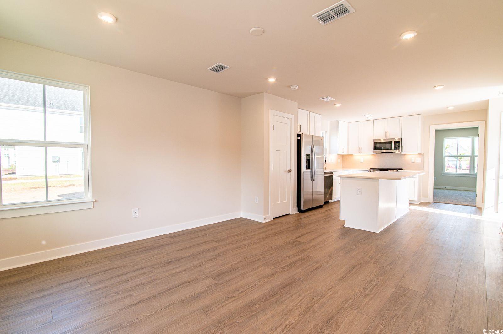 2812 Rowyn Street Longs, SC 29568 - Photo 27 of 27 Kitchen featuring a center island, white cabinets, open floor plan, stainless steel appliances, and recessed lighting