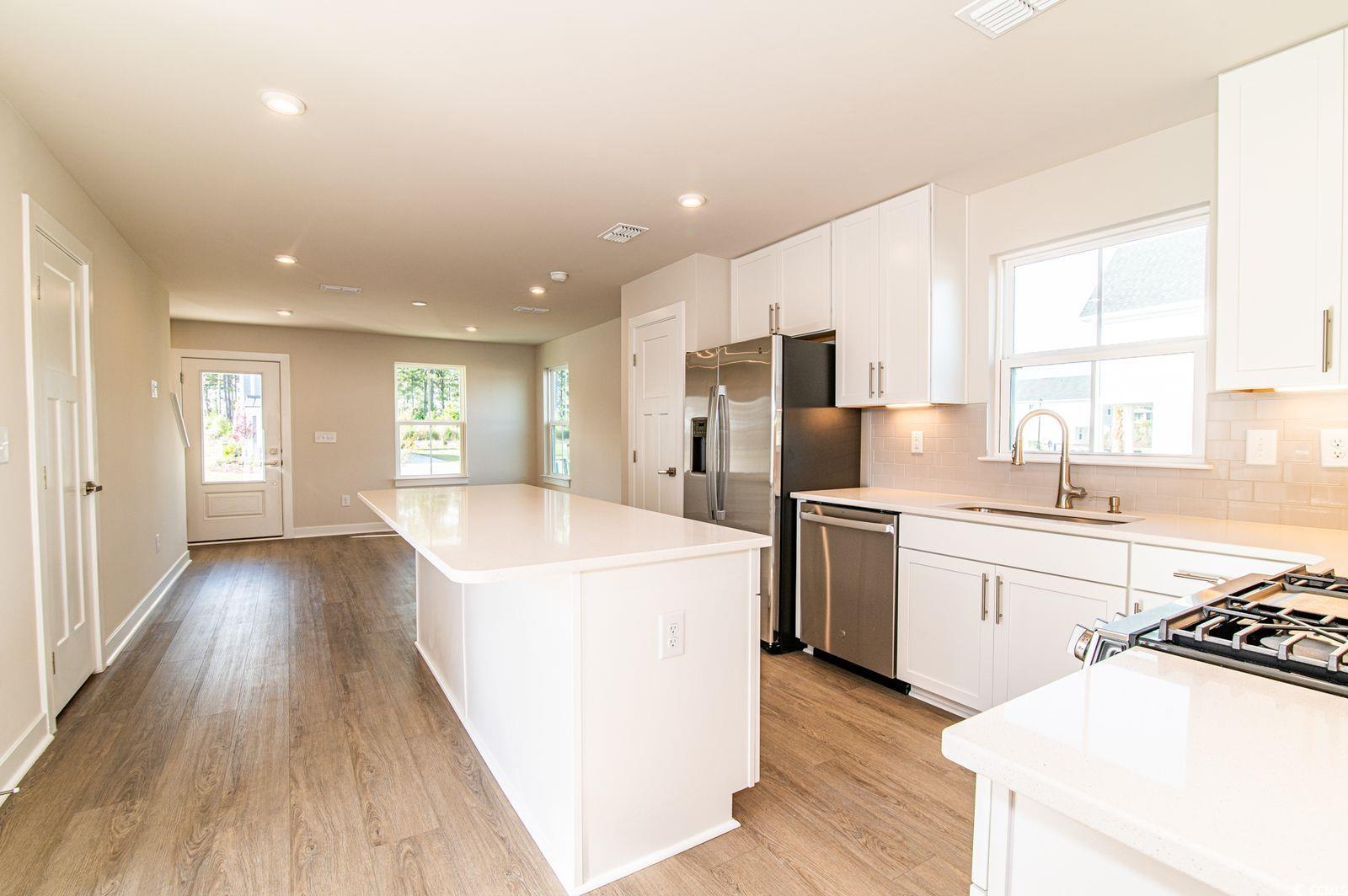 2812 Rowyn Street Longs, SC 29568 - Photo 3 of 27 Kitchen with white cabinetry, a center island, tasteful backsplash, healthy amount of natural light, and recessed lighting