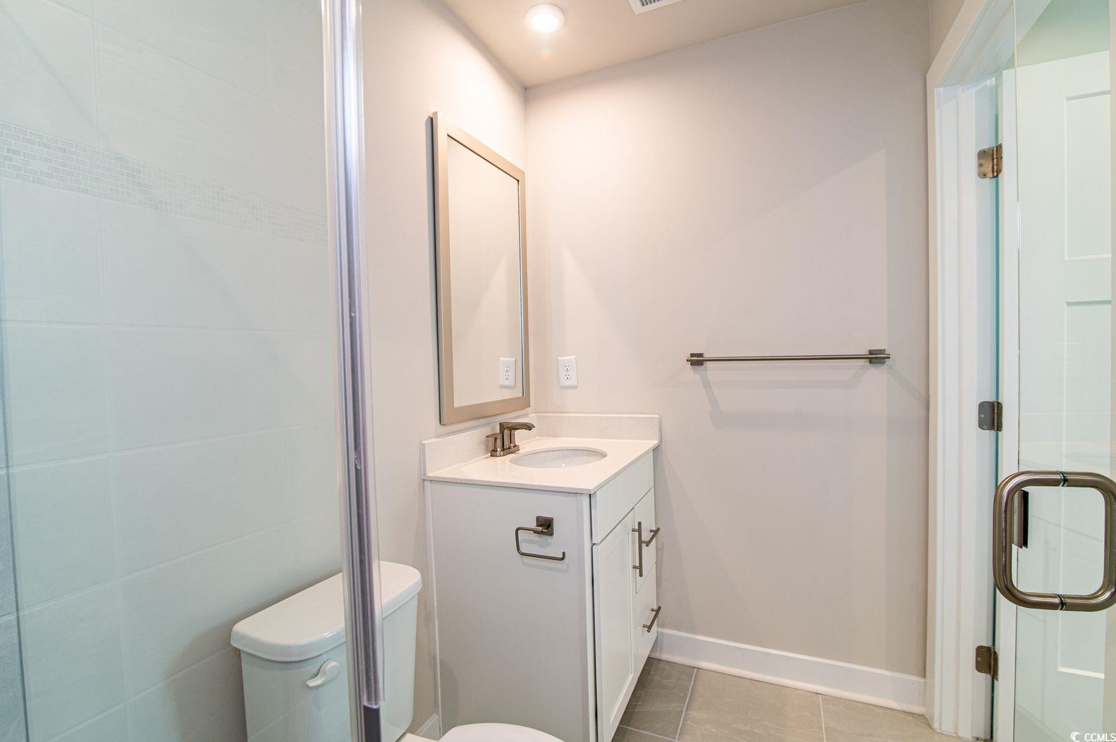 2812 Rowyn Street Longs, SC 29568 - Photo 9 of 27 Full bath with vanity, light tile patterned floors, and a shower stall
